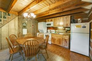 a kitchen with a table and a white refrigerator at Swiss Mountain Village in Blowing Rock