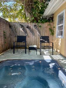 two chairs sitting on a deck next to a swimming pool at Turtle Beach Resort in Siesta Key