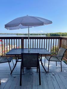 a table and chairs with an umbrella on a deck at Turtle Beach Resort in Siesta Key