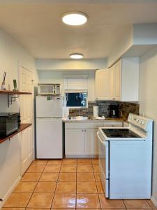a kitchen with white cabinets and white appliances at Turtle Beach Resort in Siesta Key
