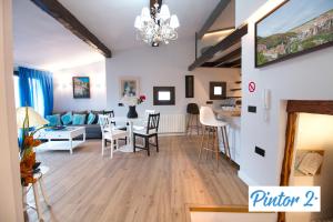 a living room and dining room with a dining table at Cuencaloft el mirador del pintor in Cuenca