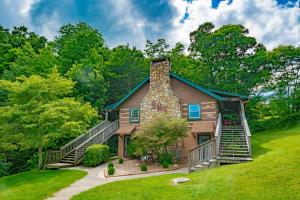 a house with a stone chimney and a staircase at Swiss Mountain Village in Blowing Rock