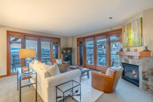 a living room with a couch and a fireplace at Capitol Peak Lodge by Snowmass Mountain Lodging in Snowmass Village