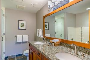 a bathroom with two sinks and a mirror at Capitol Peak Lodge by Snowmass Mountain Lodging in Snowmass Village