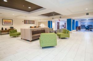 a lobby with couches and chairs in a hospital at Holiday Inn Express Hotel & Suites Biloxi- Ocean Springs, an IHG Hotel in Ocean Springs
