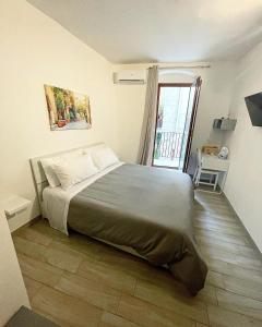 a bedroom with a bed and a large window at Corte San Gaetano in Bari