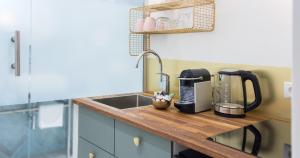 a kitchen with a sink and a coffee maker on a counter at Nikolai Homes in Vienna