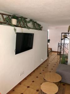a living room with a flat screen tv on a wall at La Casita de Peñíscola - Somhome in Peñíscola