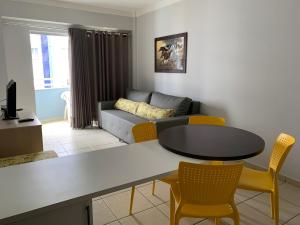 a living room with a table and chairs and a couch at Aguas da Serra 322 A in Rio Quente