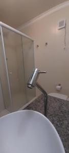 a bathroom with a sink and a mirror at Aquarela Bombinhas in Bombinhas