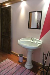 a bathroom with a white sink and a mirror at Le Château de mon Père in Villiers-aux-Corneilles