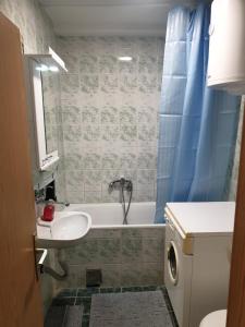 ein Badezimmer mit einem Waschbecken, einer Badewanne und einem WC in der Unterkunft City center apartment 2 in Niš
