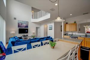 a living room with a blue couch and a kitchen at SOLANA 7 Bed Rooms FAMILY VACATION VILLA-Private Pool and SPA in Davenport
