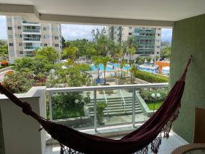 a hammock on a balcony with a view of a pool at Apartamento Olof in Rio de Janeiro