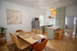 a kitchen and dining room with a table and chairs at Willow McLaren Vale in McLaren Vale