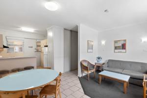 a living room with a couch and a table at Taft Apartments in Adelaide