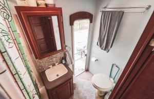 a bathroom with a sink and a toilet and a mirror at Rv adventure Roscoe Pet friendly in Roscoe