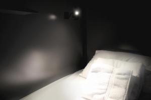 a bed with a white comforter and pillows at Nap York Central Park Sleep Station in New York