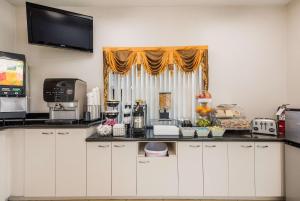 a kitchen with a counter top with a window at SureStay Hotel by Best Western Sarasota Lido Beach in Sarasota