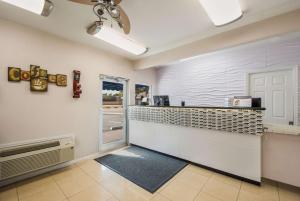 a kitchen with a counter and a door in a room at SureStay Hotel by Best Western Sarasota Lido Beach in Sarasota