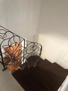 a metal railing on a stair case with stairs at Casa Funchal Master in Lençóis