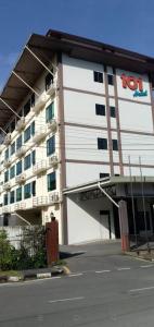 a large white building with a t top sign on it at 101 Hotel in Miri