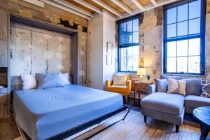 A bed or beds in a room at Sterchi Lofts Getaway - Downtown Knoxville