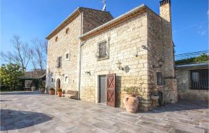 a large brick building with a door and a courtyard at Cozy Home In Fragneto Monforte With House A Panoramic View in Fragneto Monforte