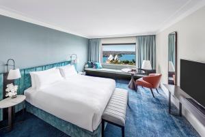 a hotel room with two beds and a television at InterContinental Sydney, an IHG Hotel in Sydney
