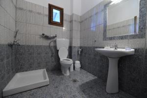a bathroom with a toilet and a sink at Thalassa Hotel in Ammouliani