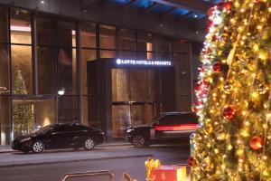 a christmas tree in front of a building at Lotte Hotel Hanoi in Hanoi