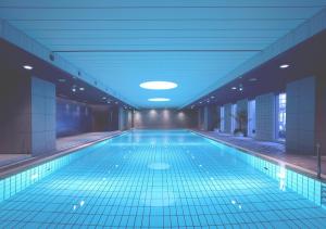 a large swimming pool in a large room at Hotel Granvia Kyoto in Kyoto