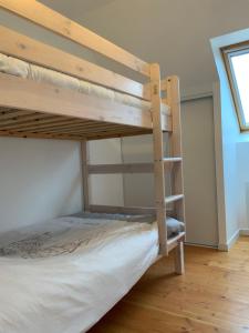 a bunk bed in a room with a ladder at Maison TY Traon - in Audierne