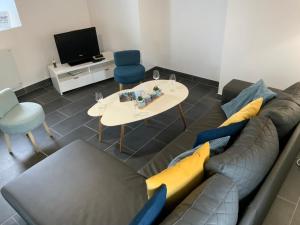 a living room with a couch and a table and a tv at Maison TY Traon - in Audierne