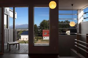 a room with a window with a view of a building at Orchid Furano in Furano +15 photos