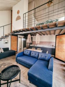 a living room with a blue couch and a table at Little Escape in Santa Teresa Beach