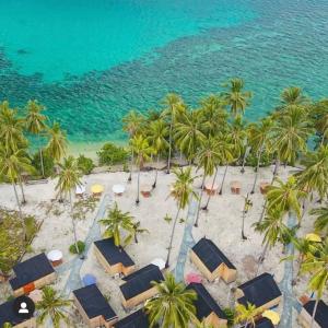 an aerial view of a beach with palm trees at Pulau Mahitam Resort & Cottage by Hotelku in Ratai