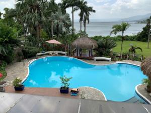 una piscina con vista sull'oceano di AWILIHAN PRIVATE PARADISE RESORT a Ambulong