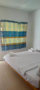 a white bed in a room with a window at Sweet Time Bungalows in Koh Rong Sanloem
