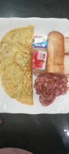 a plate of breakfast food with eggs bacon and bread at Sweet Time Bungalows in Koh Rong Sanloem
