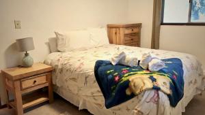 a bedroom with a bed with stuffed animals on it at Captain's Quarters - Reduced Price Tours! in Mendenhaven
