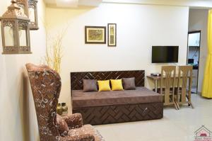 a living room with a couch and a chair at Furnished 2BHK Independent Apartment 8 in Greater Kailash - 1 with 2 Balconies in New Delhi