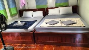 
a bed that has two pillows on it at White Rose Guesthouse in Koh Rong Island
