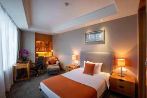 Voodi või voodid majutusasutuse Shanghai Tiancheng Hotel toas