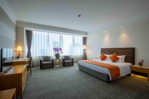 Voodi või voodid majutusasutuse Shanghai Tiancheng Hotel toas