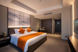 Voodi või voodid majutusasutuse Shanghai Tiancheng Hotel toas