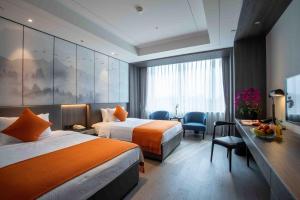 Voodi või voodid majutusasutuse Shanghai Tiancheng Hotel toas