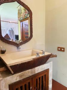 a bathroom with a sink and a mirror at Sapulidi Cafe, Gallery & Resort in Lembang +23 photos