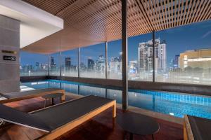 a swimming pool with a view of a city skyline at Wyndham Garden Bangkok Sukhumvit 42 in Bangkok