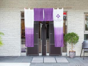 a pair of purple and white curtains on a building at Kyoto Four Sisters Residence in Kyoto